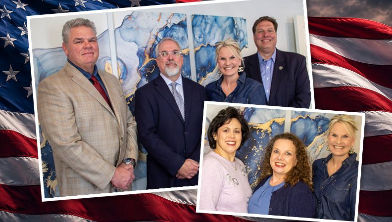 Patriot Title attorneys and staff in front of an American flag