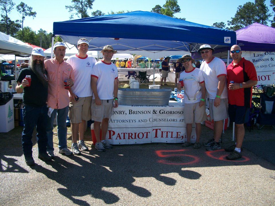 Patriot Title team at a crawfish cook-off under their Patriot Title banner