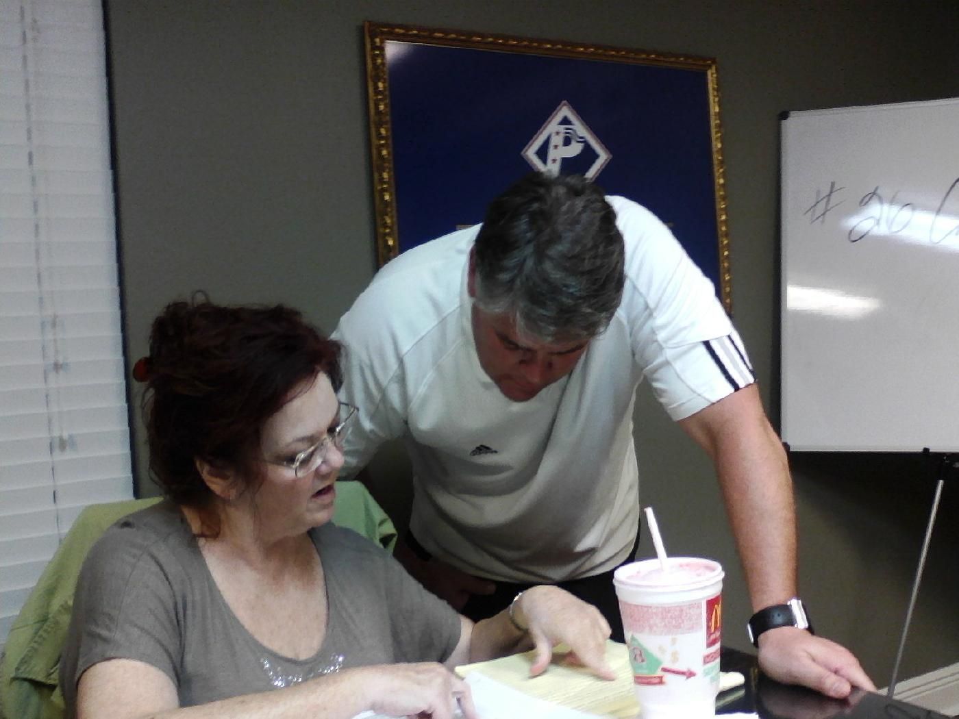 An instructor helping a student during a Patriot Title notary class